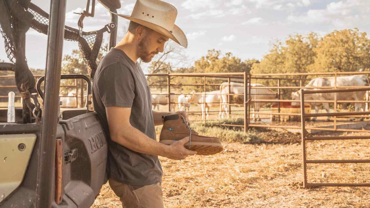 cowboy holding work boots