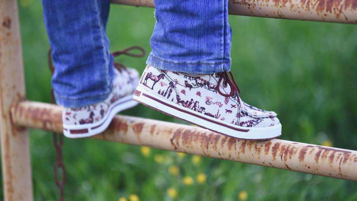Twisted X shoes on a gate